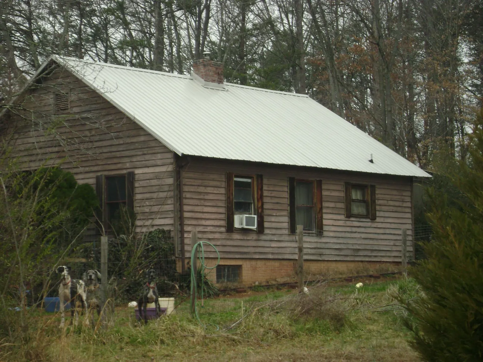 White metal roof on an old wood sided farmhouse, from a Asphalt Shingle Roof Repair job in Paris